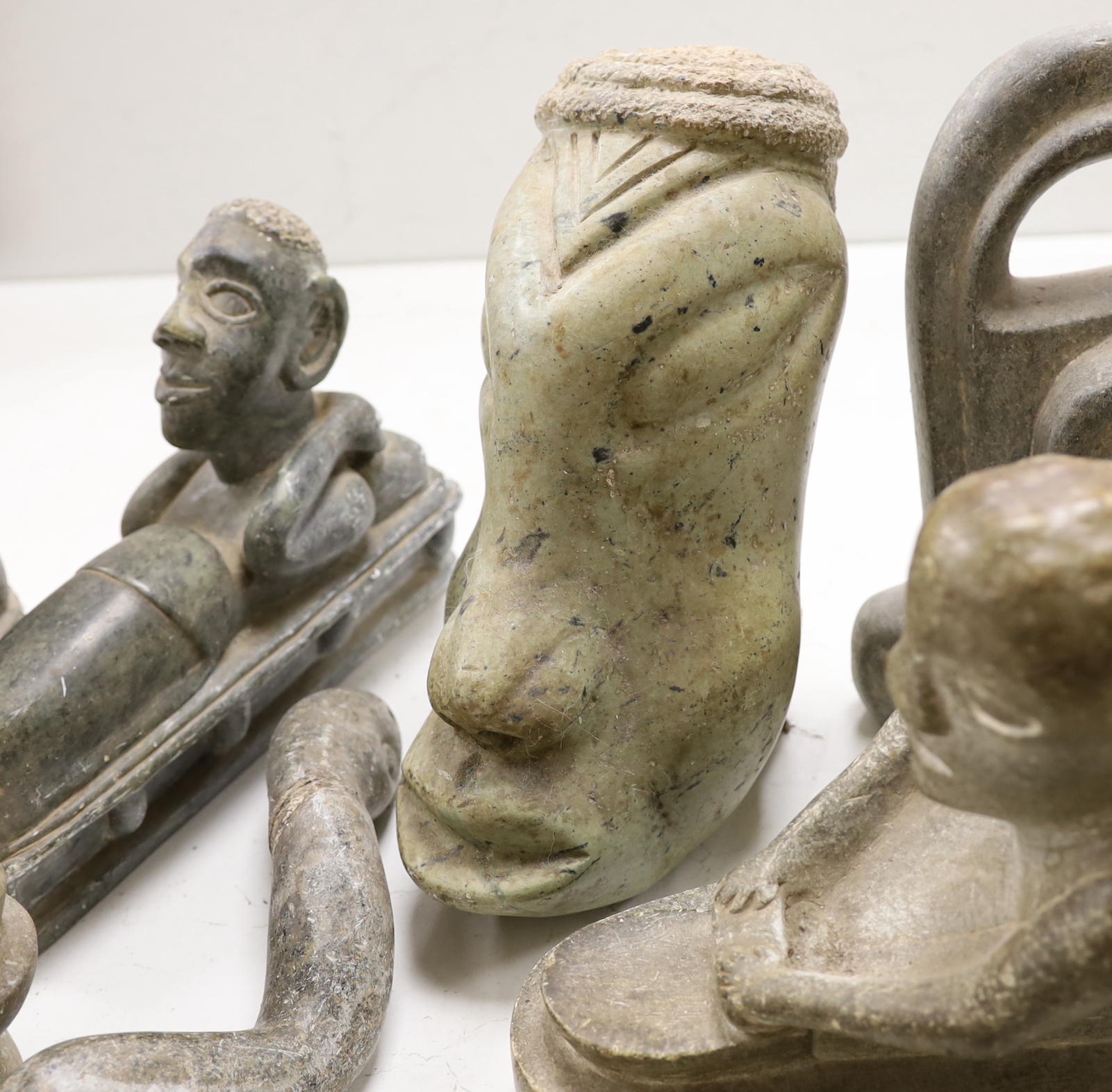 Eight Shona stone carvings, 1960s-70s including a kneeling figure and sleeping figure,both signed D.S. Dube, other figures, heads and abstract sculpture forms, tallest 35cm